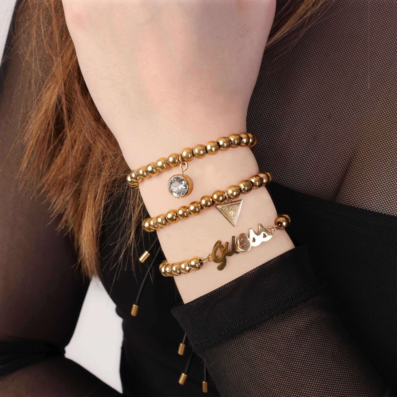 Guess stainless steel goldplated kralenarmband met letterhanger voor dames