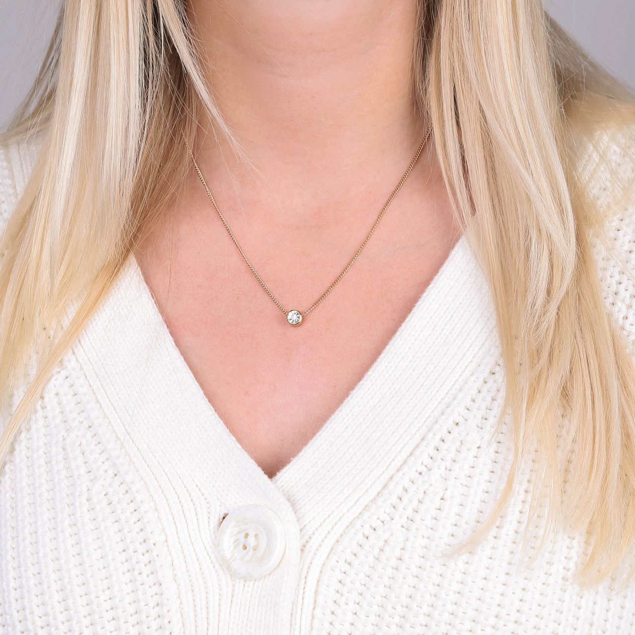 Goudkleurige byoux ketting in een Kerstbal