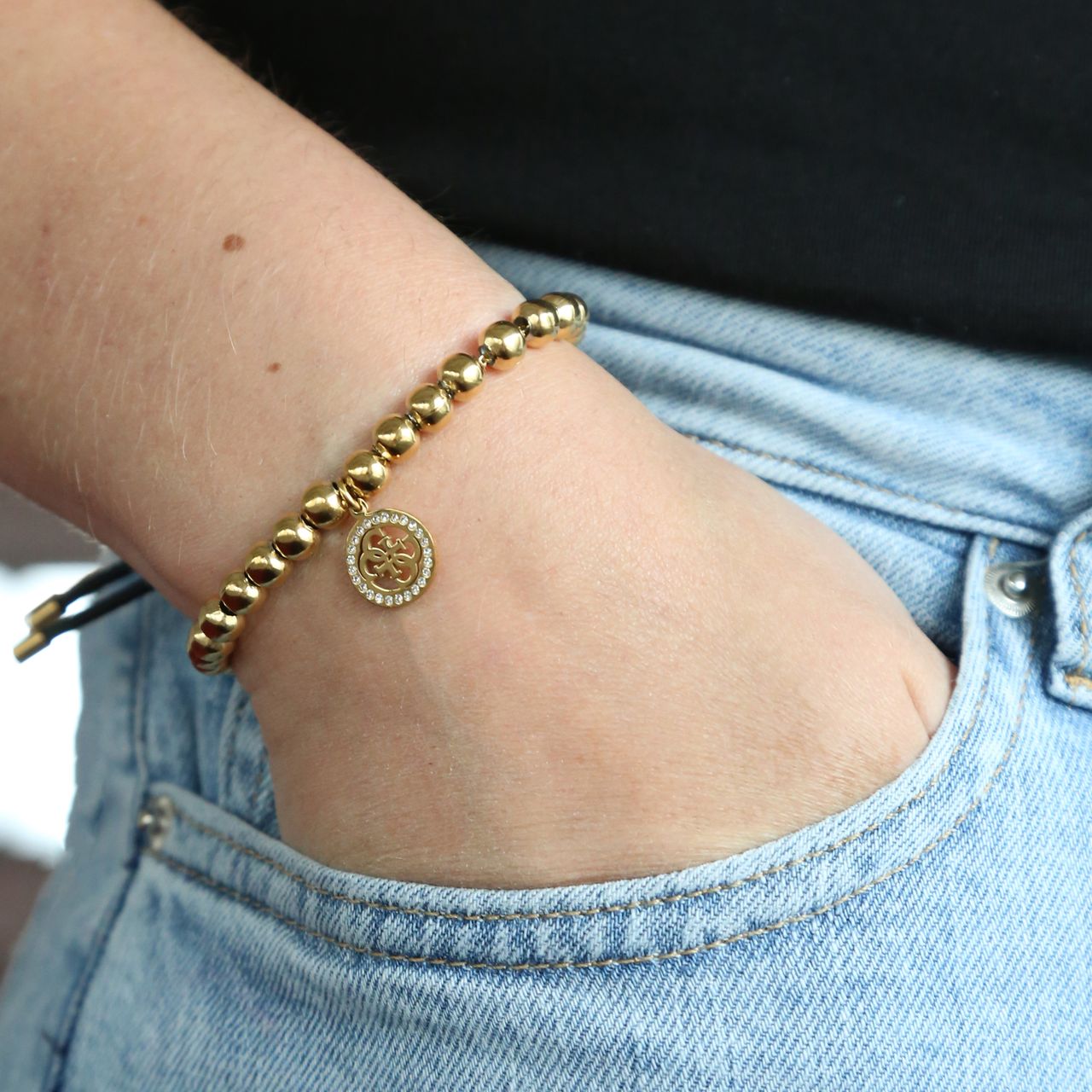 Guess stainless steel goldplated kralenarmband met hanger met kristal voor dames