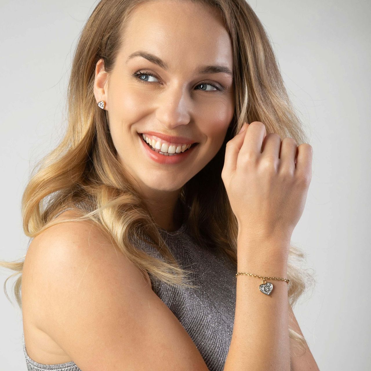 Guess stainless steel goldplated bedelarmband met hanger hart met kristal voor dames