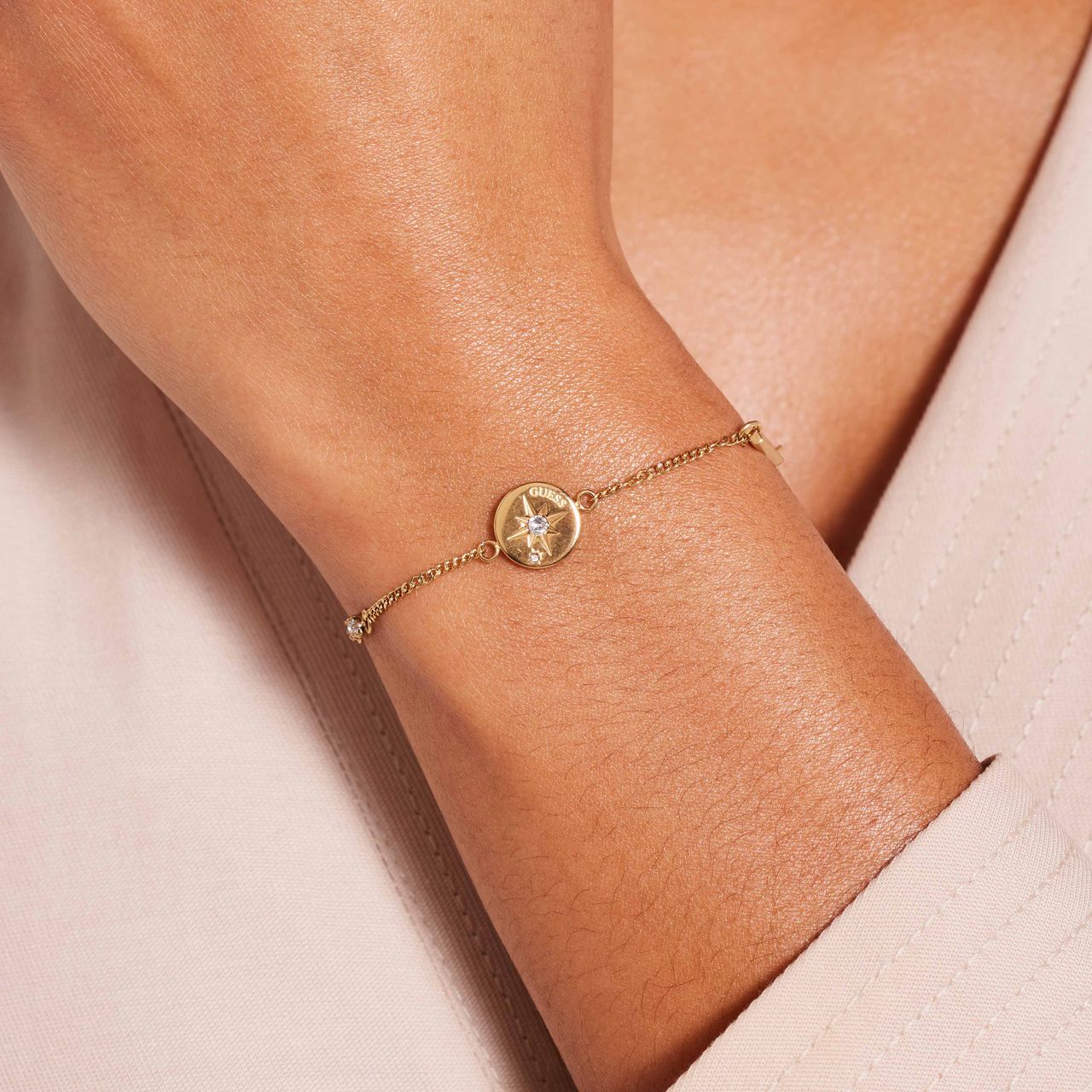 Guess stainless steel goldplated schakelarmband met kristal voor dames