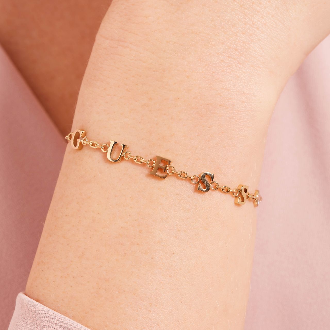 Guess stainless steel goldplated schakelarmband met kristal voor dames