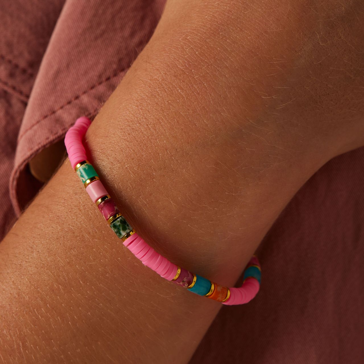 Stalen goldplated armband met fuchsia kralen