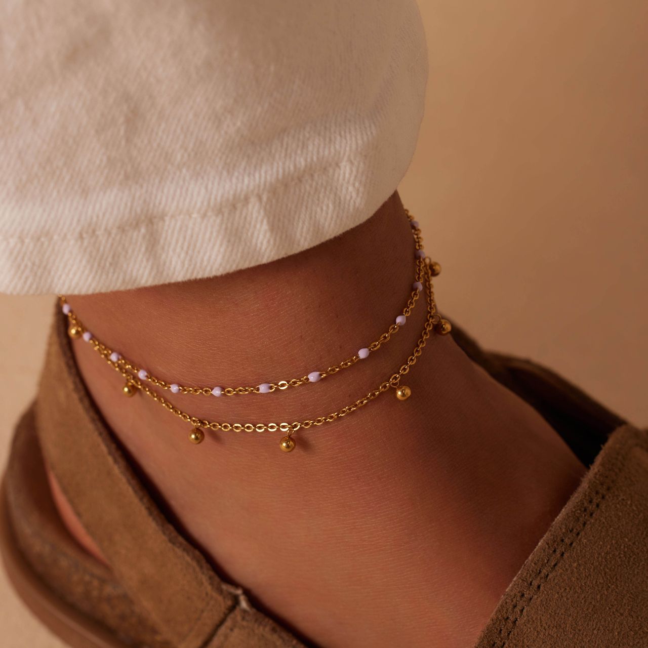 Dubbele goldplated stalen enkelband met bedeltjes