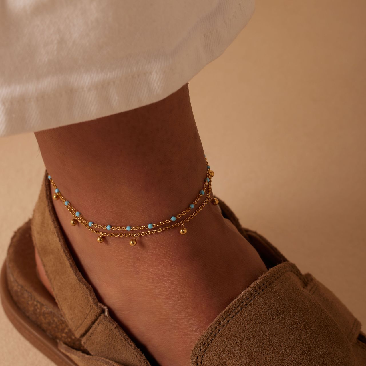 Dubbele goldplated stalen enkelband met bedeltjes