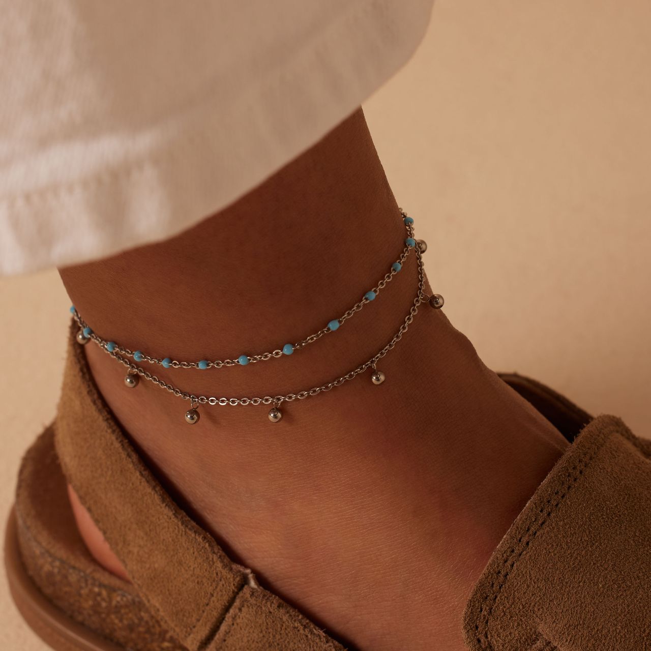 Dubbele stalen enkelband met bedeltjes