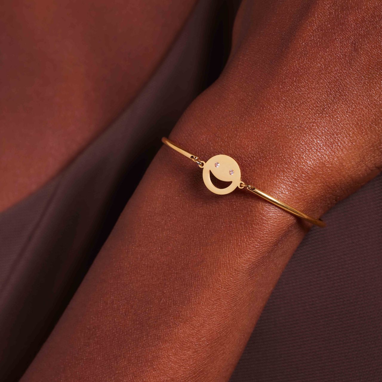 Stainless steel goldplated armband smiley met roze zirkonia