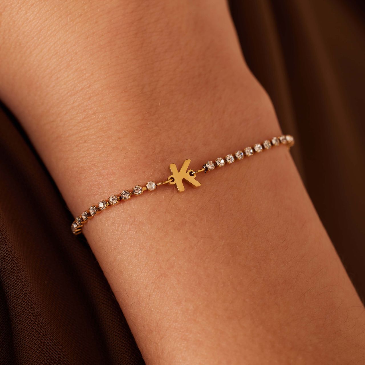 Stainless steel goldplated tennis armband wit cz letter - K