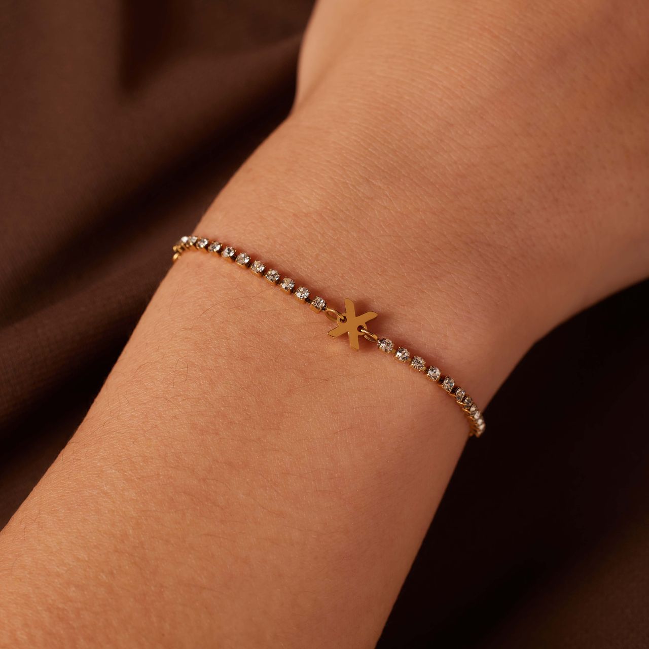 Stalen goldplated tennis armband wit cz letter - X