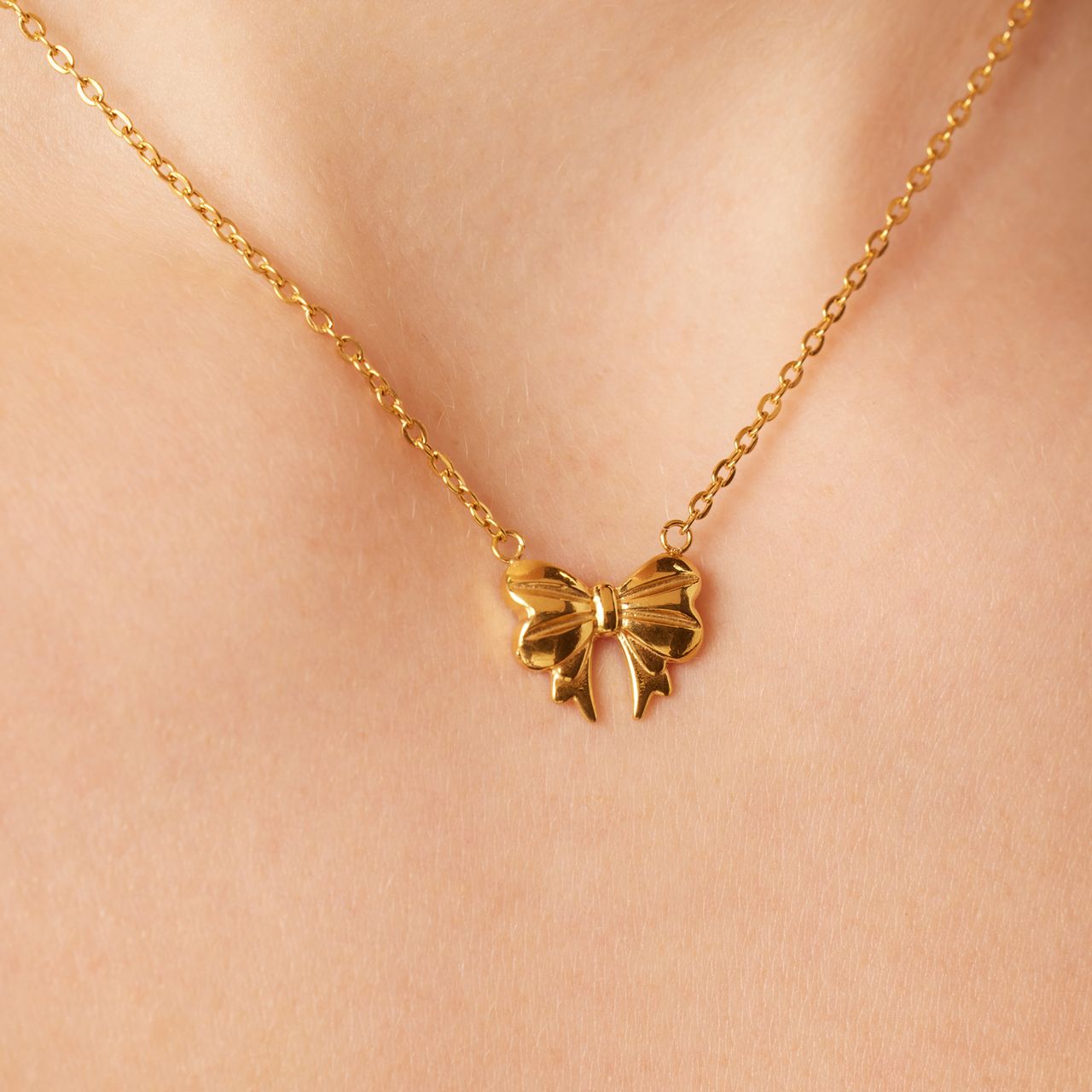 Stalen goldplated ketting met hanger strik voor dames