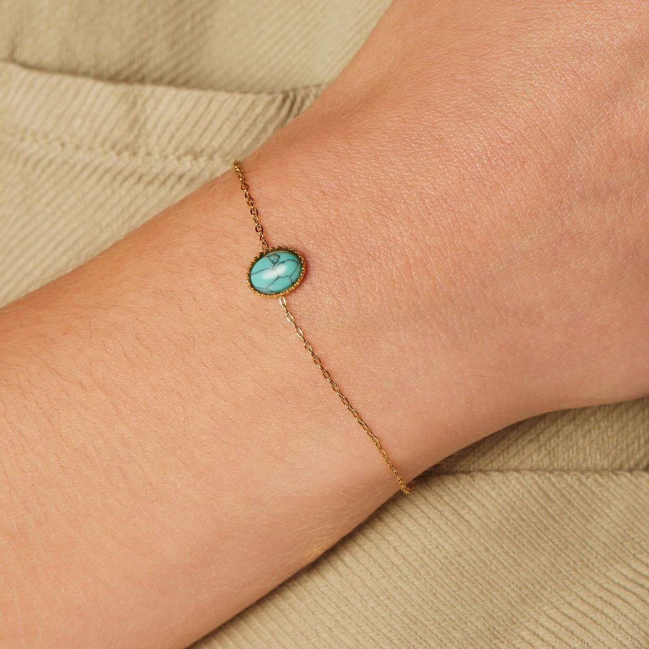 Stalen goldplated armband bol met turquoise