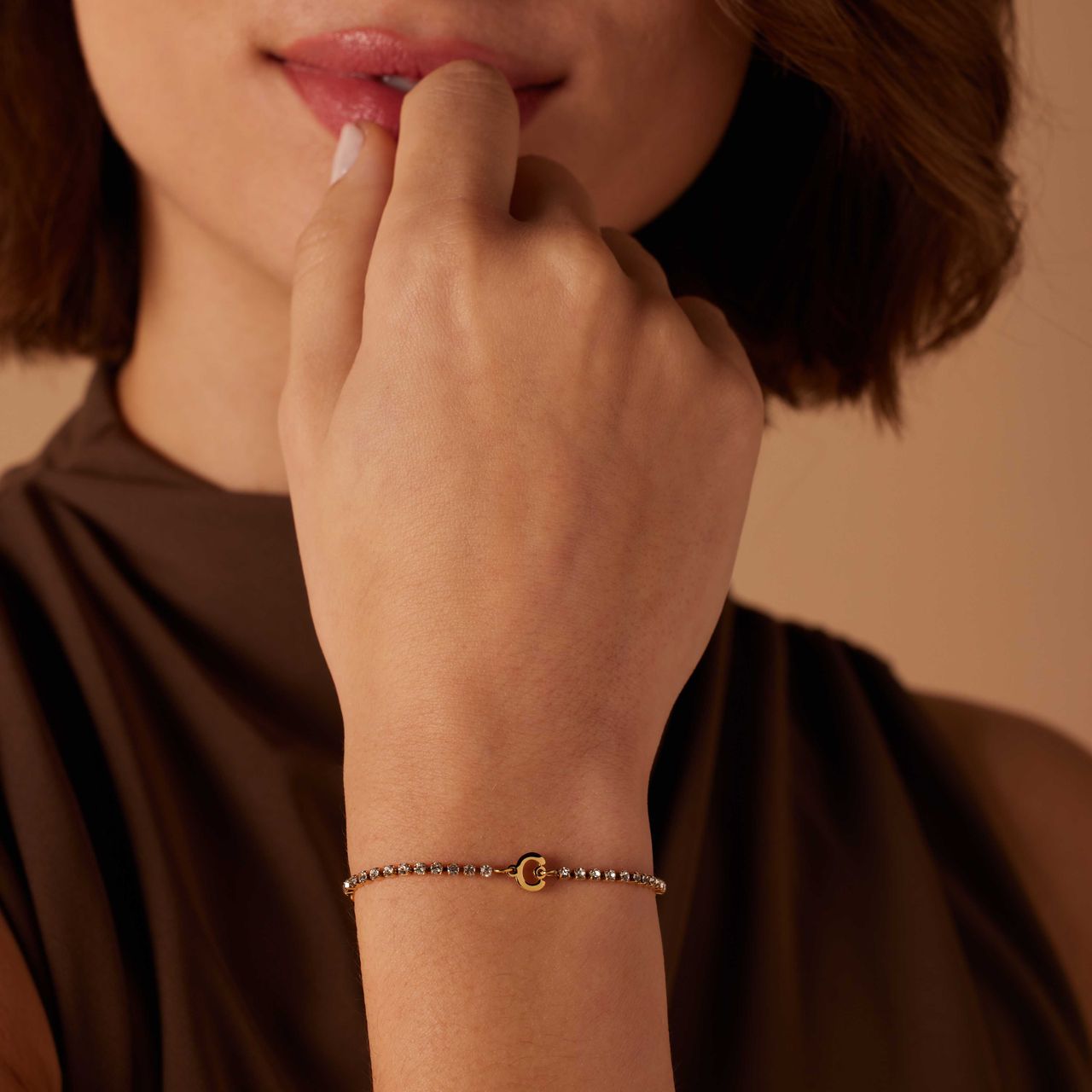 Stalen goldplated tennis armband wit cz letter - C