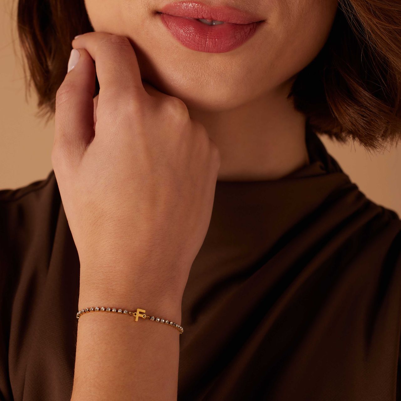 Stalen goldplated tennis armband wit cz letter - F