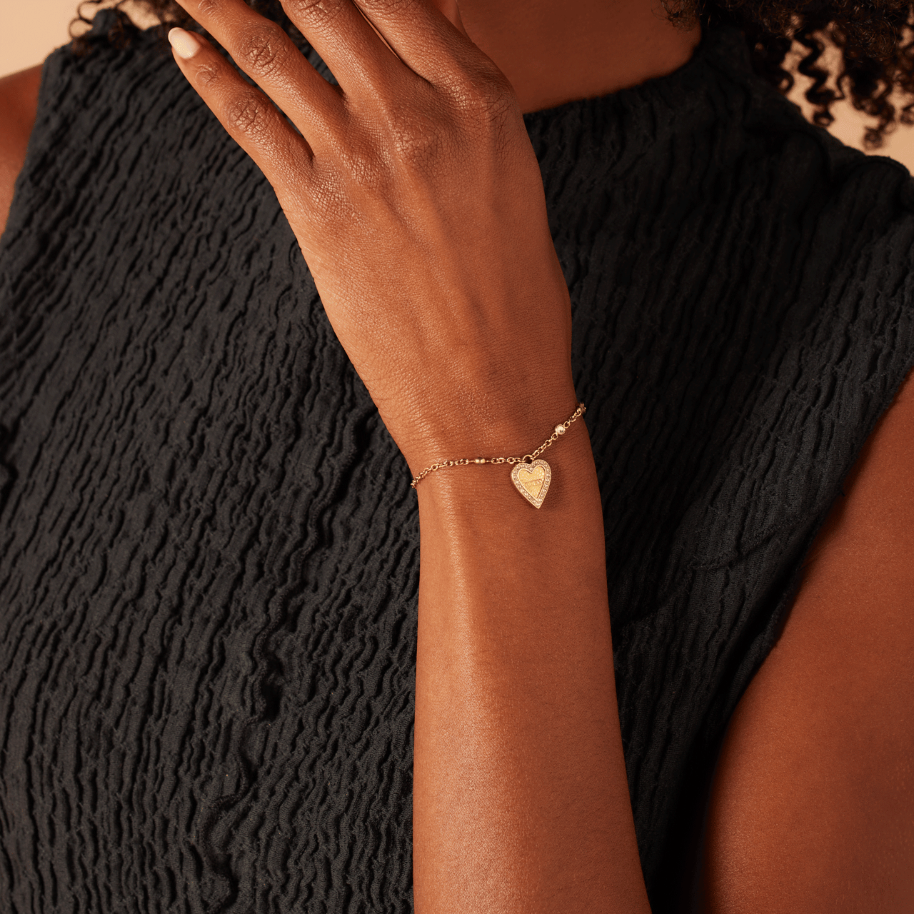 Guess stainless steel goldplated fantasiearmband met hanger hart met kristal voor dames