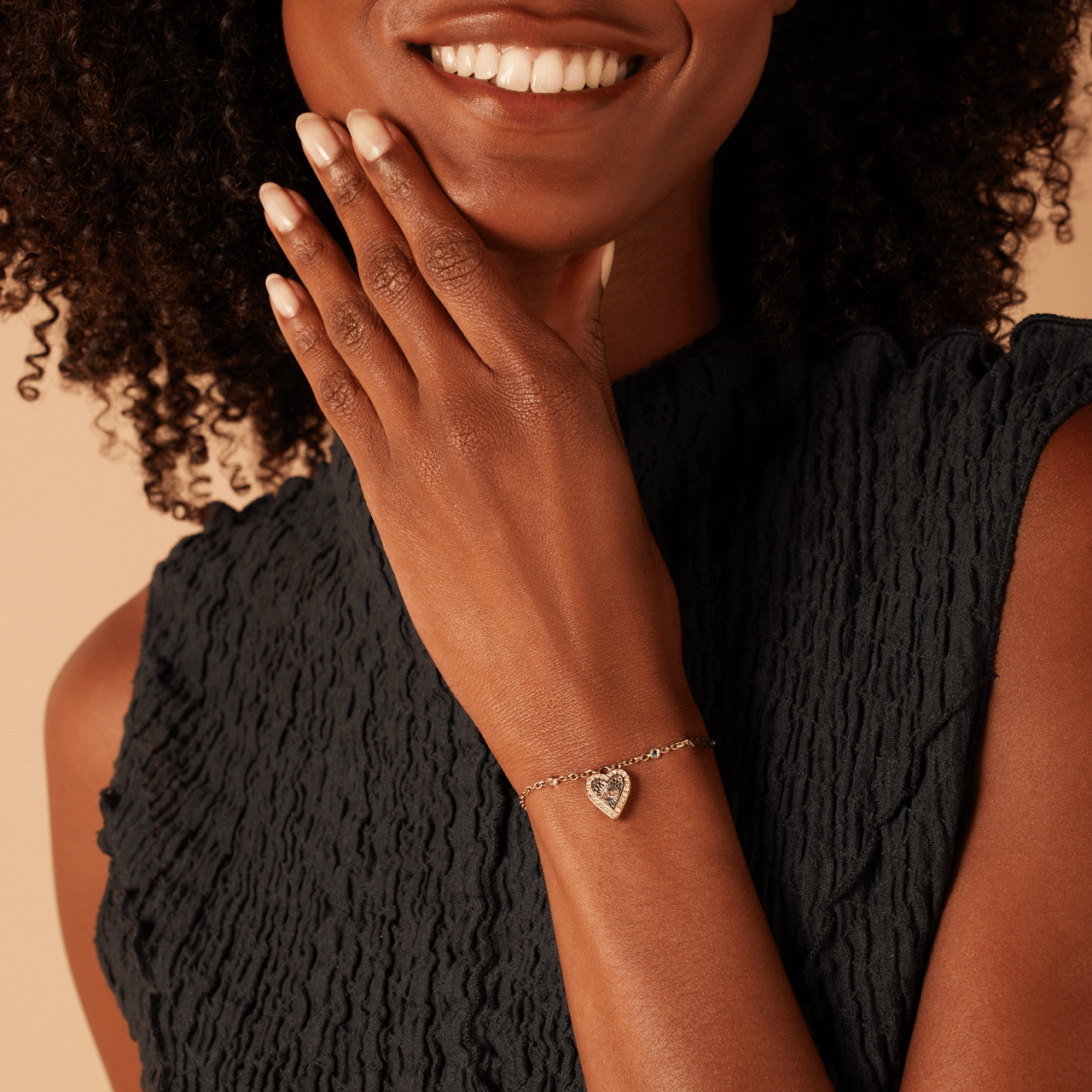 Guess stainless steel goldplated fantasiearmband met hanger hart met kristal voor dames