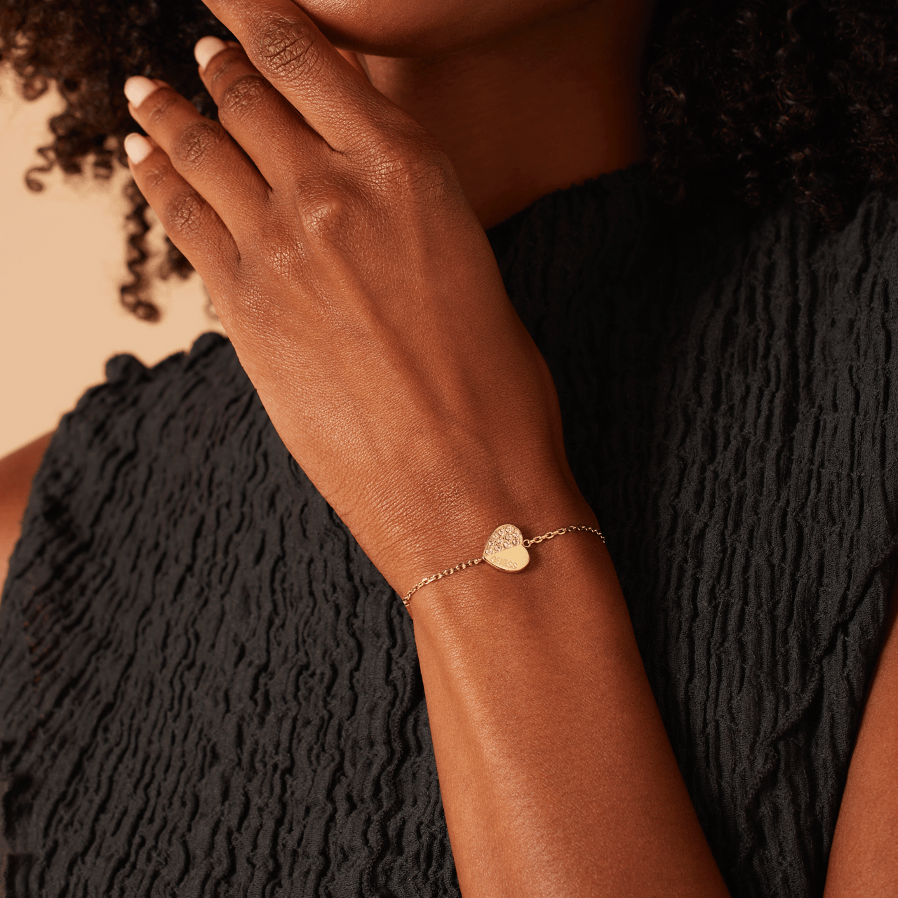 Guess stainless steel goldplated fantasiearmband met hanger hart met kristal voor dames