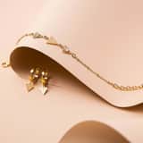 Guess stainless steel goldplated oorringen triangle met hanger voor dames