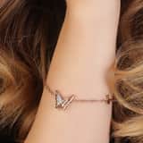 Guess stainless steel roséplated fantasiearmband met hanger vlinder met kristal voor dames
