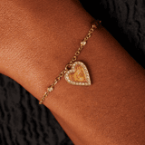 Guess stainless steel goldplated fantasiearmband met hanger hart met kristal voor dames