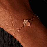 Guess stainless steel roséplated fantasiearmband met hanger hart met kristal voor dames