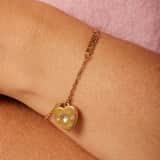 Guess stahlfarbenes, goldplattiertes Armband AMORE