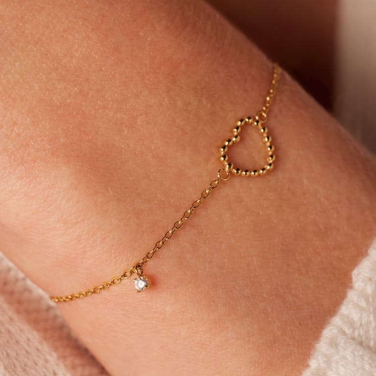 Stainless steel goldplated armband met open hart bol