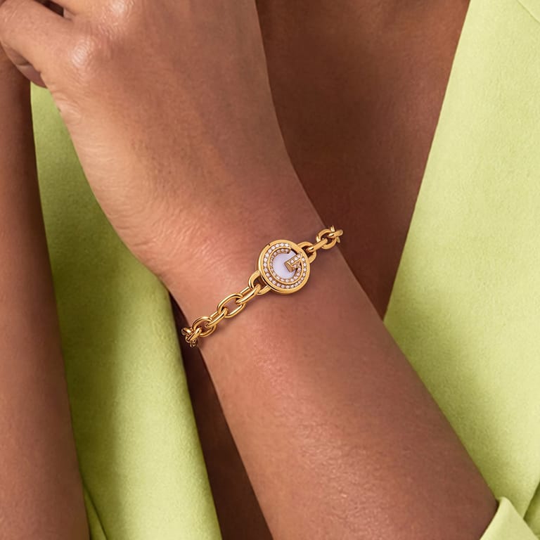 Guess stainless steel goldplated fantasiearmband met munt met kristal voor dames